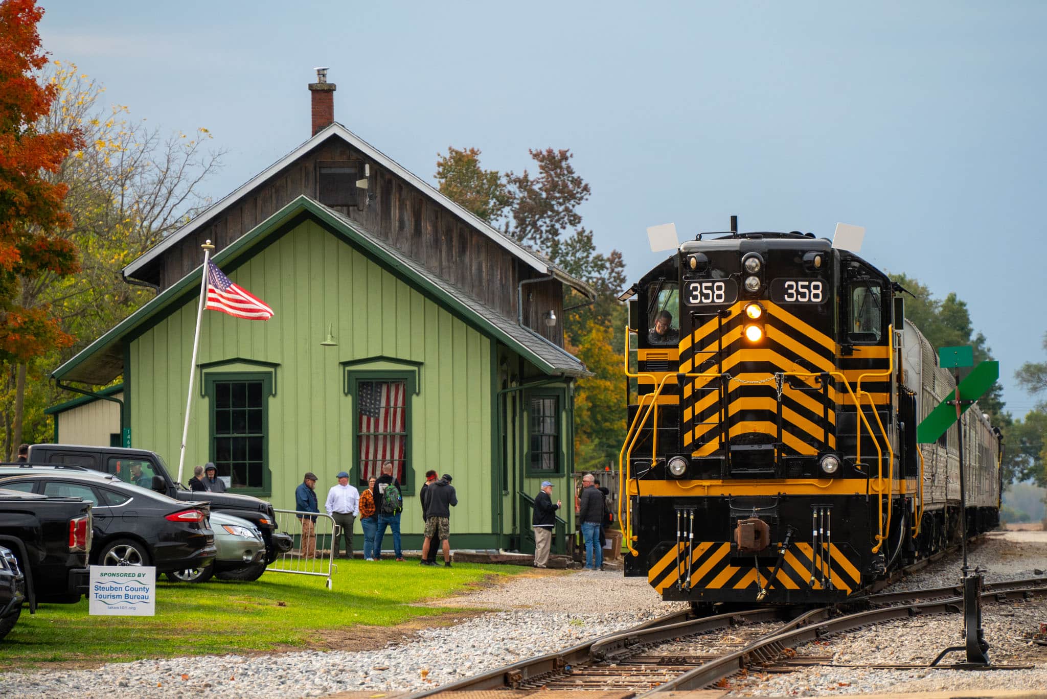 Rudy Mahara is second from locomotive center.
Nickel Plate Road SD9 No. 358 builds air into the vintage rail cars outside the Pleasant Lake, Indiana station undergoing repainting. Engineer Will Carney is runniing the classic restored locomotive on  the Rocky Patel Rolling Smoke Cigar Train round-trip between here and Hillsdale, Mich., on Oct. 12, 2024.
Steve Smedley